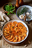 Roasted slices of sweet potato served in a baking form