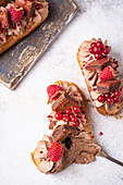 Eclairs with chocolate cream, brownie and berries