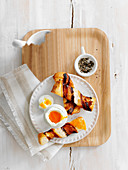 Soft boiled egg with pancetta wrapped soldiers