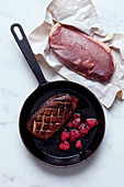 Grilled duck breast with raspberries