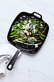 Green asparagus with parmesan in a pan