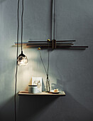 Pendant lamp with long cable above wall shelf
