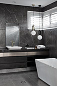 Marble tiles in modern, masculine bathroom decorated in black and grey