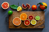 Various citrus fruits, partly in slices and pieces