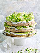 Pistachio, lime and coconut cream cake with melon, apple and mint