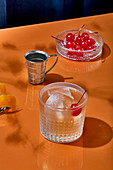 Bourbon Cocktail with cherry and ice cubes