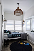 Small boys' room in grey tones with louvre windows