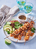 Chicken skewers with red quinoa and avocado