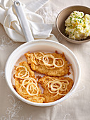 Baked upturned schnitzel with onion