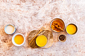 Selection of Golden Milks with Plant Milk, Syrup and Ground Turmeric
