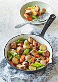 Fried sausages with new potatoes and vegetables