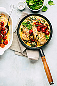 Spicy chicken breast with coconut, tomatoes and spinach