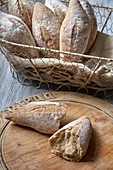 Sourdough bread rolls spilling out of a basket