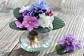 A small bouquet of various flowers of African violets leaves as cuff
