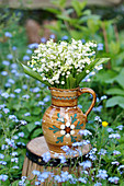 Bouquet of lily-of-the-valley in rustic ceramic jug
