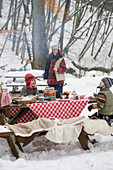 Picnic with children in the snowy forest