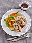 Turkey roll with vegetables and cranberry sauce