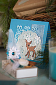 A DIY Christmas card with a blue-and-white deer motif