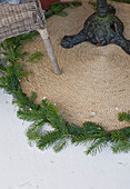 Round outdoor rug decorated with spruce branches
