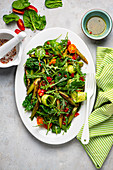 Asparagus salad with spinach, cucumber and tomato