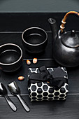Present in black-and-white gift wrap and black tea service
