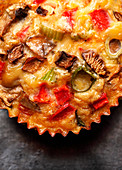 Omelette muffin with peppers, mushrooms and spring onions (close-up)