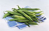 Runner beans on a blue and white cloth