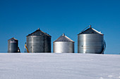 Grain storage bins in winter