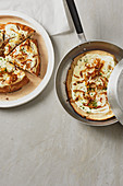 Pan-fried tarte flambé with sour cream, bacon and chives