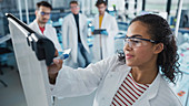 Scientist writing on whiteboard