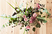 Autumn bouquet with roses, eucalyptus, love-in-a-mist seed heads, great burnet, sedum, pink pepper and chrysanthemums