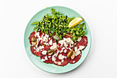 Beef carpaccio with arugula and cheese