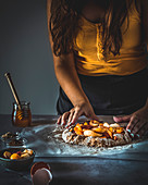 Girl making a stone fruit galette