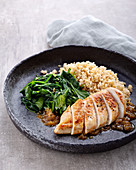 Chicken in a lemon sauce with a spinach medley and spelt bulgur