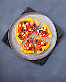 Polenta pizza with tomatoes, peppers, olives and feta cheese