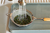 Legumes being washed with cold water
