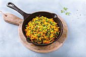 Fried turmeric rice with carrots and peas