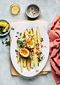 White asparagus with a baked egg and radish vinaigrette
