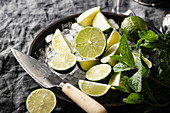 Sliced limes and mint over ice