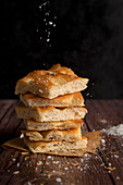 Sliced focaccia bread with salt and olive oil