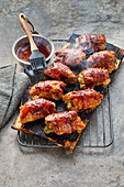 Plank cooked BBQ chicken thighs with jalapenos, bacon and cream cheese