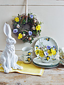 Easter wreath of branches, box, flowers and quail eggs and posy of primulas, violas and lisianthus