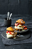 Cream puff burger with strawberries, eggnog cream and rosemary brittle