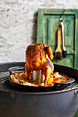 Beer can chicken on a grill