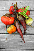 Topview colored vegetables from the garden ship red beetroot outside on old grey deck