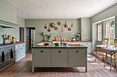 Light green modernised kitchen in 18th century mansion