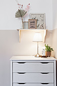 Table lamp on chest of drawers in child's bedroom