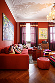 Red living room with many cushions