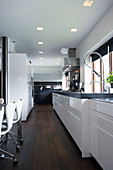 White fitted kitchen with black granite worksurface