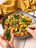 Oriental quinoa salad with sweet potatoes, almonds and mint